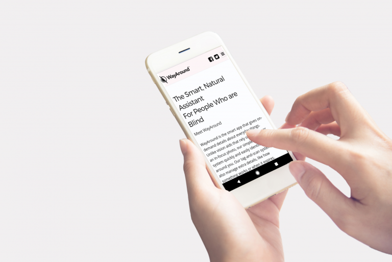woman's hands holding smart phone showing WayAround homepage