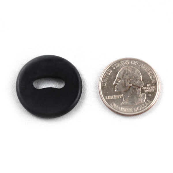 Front side of a black oval hole button next to a quarter. The oval hole button is slightly larger than the quarter.