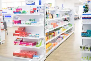 Shelves of creams and medicines at a pharmacy.